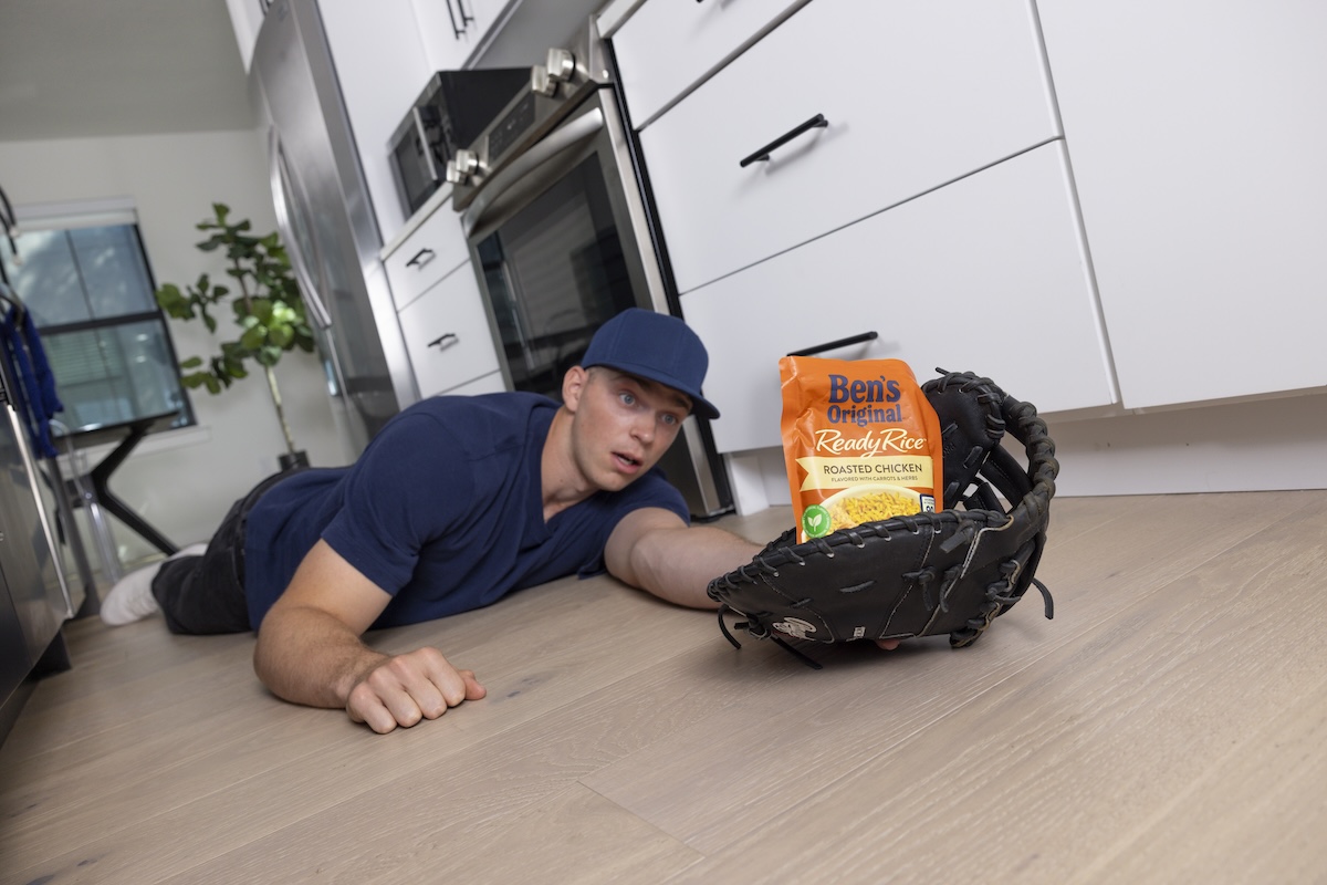 Baseball player Ben Rice "catches" a package of Ben's Original rice