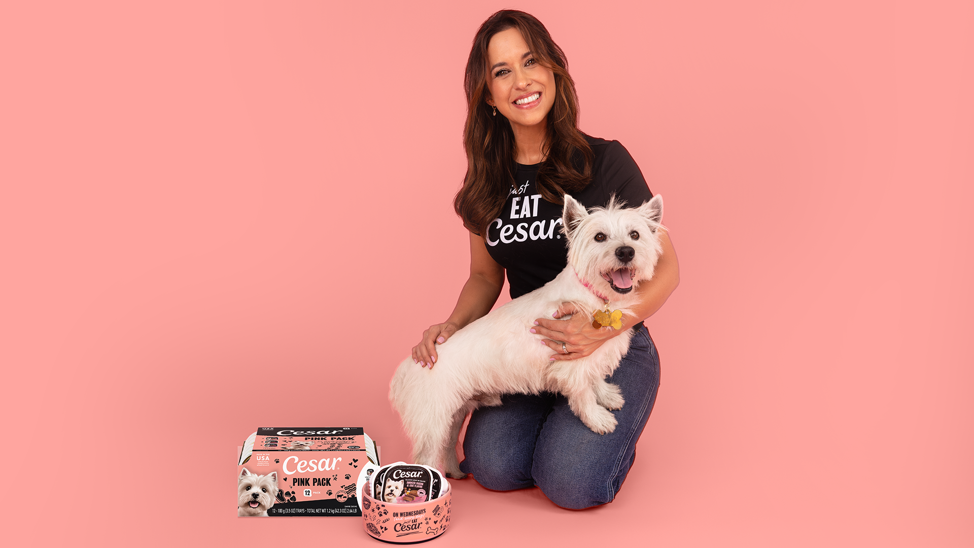 Lacey Chabert poses with the CESAR dog mascot and limited-edition Pink Packs.