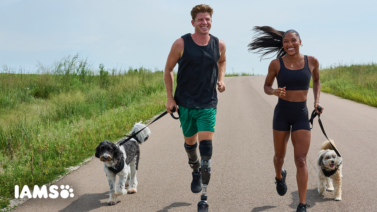 Gold medalists Tara Davis-Woodhall and Hunter Woodhall run outside with their dogs, Milo and Winnie.