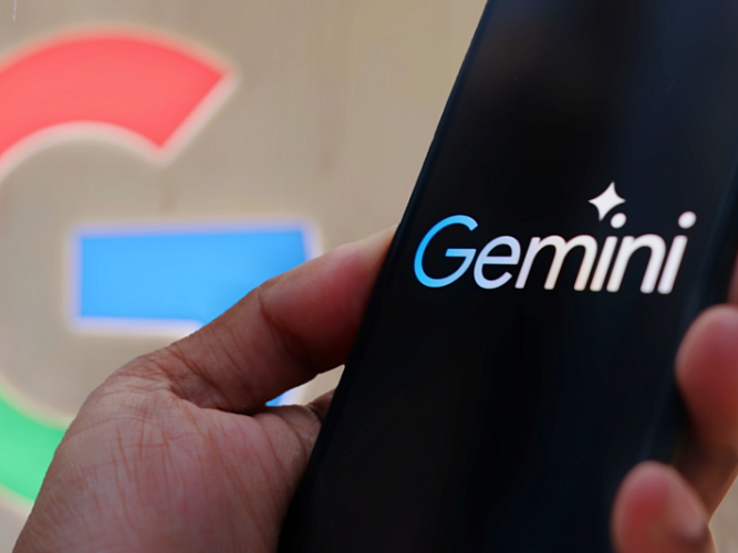 The Google logo and a hand holding a smartphone with Google Gemini on screen.