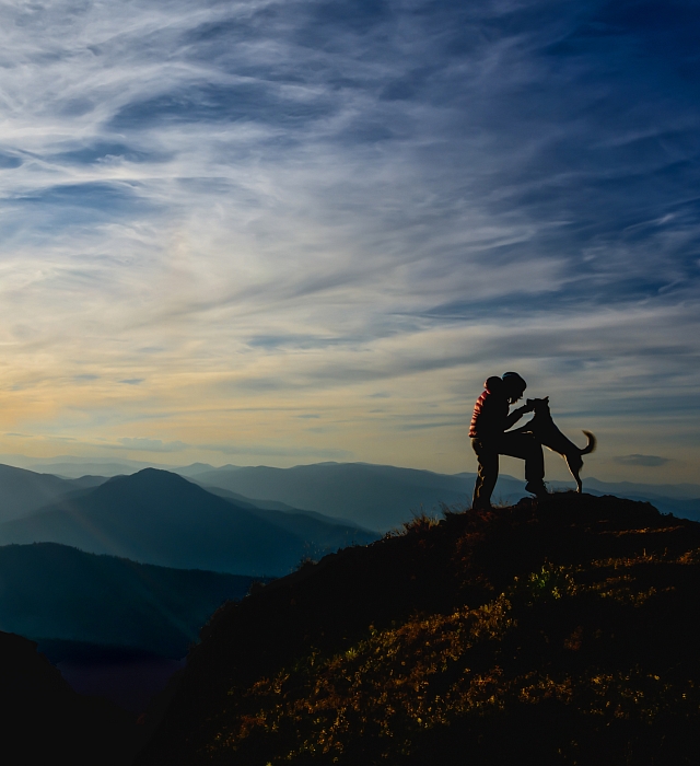 Man with dog on a mountain