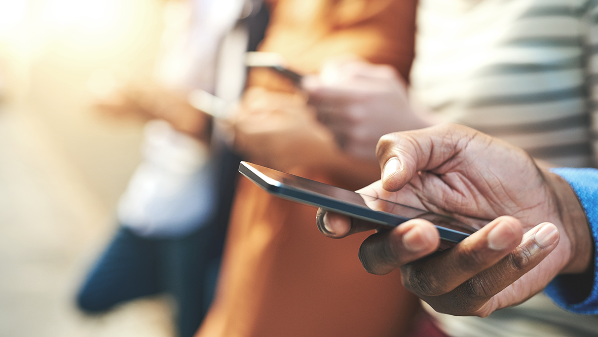 A hand holding a smart phone