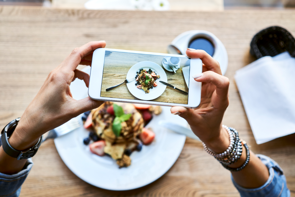A women takes a picture of her delicious meal