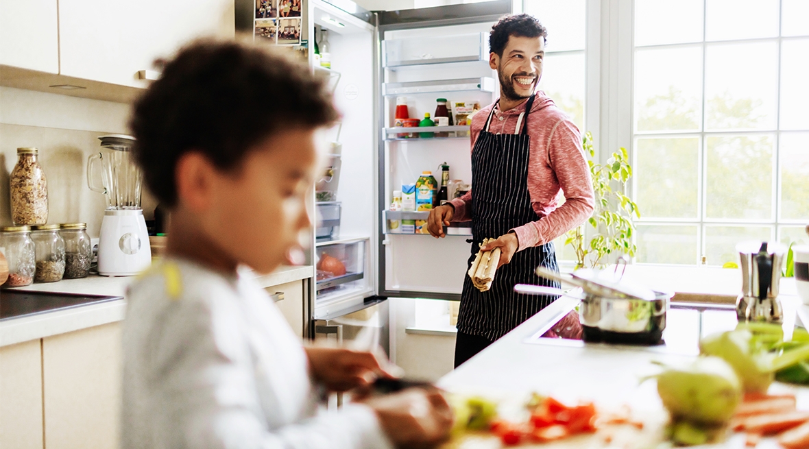 Father and son cooking in kitchen
