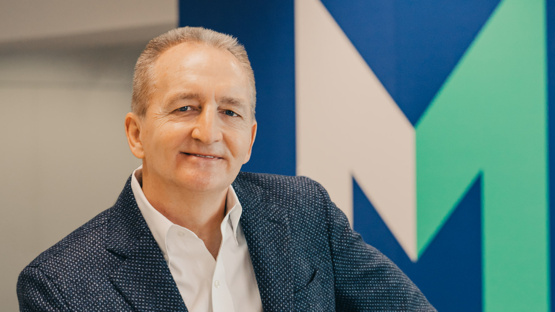 Grant F. Reid in front of the Mars "M"