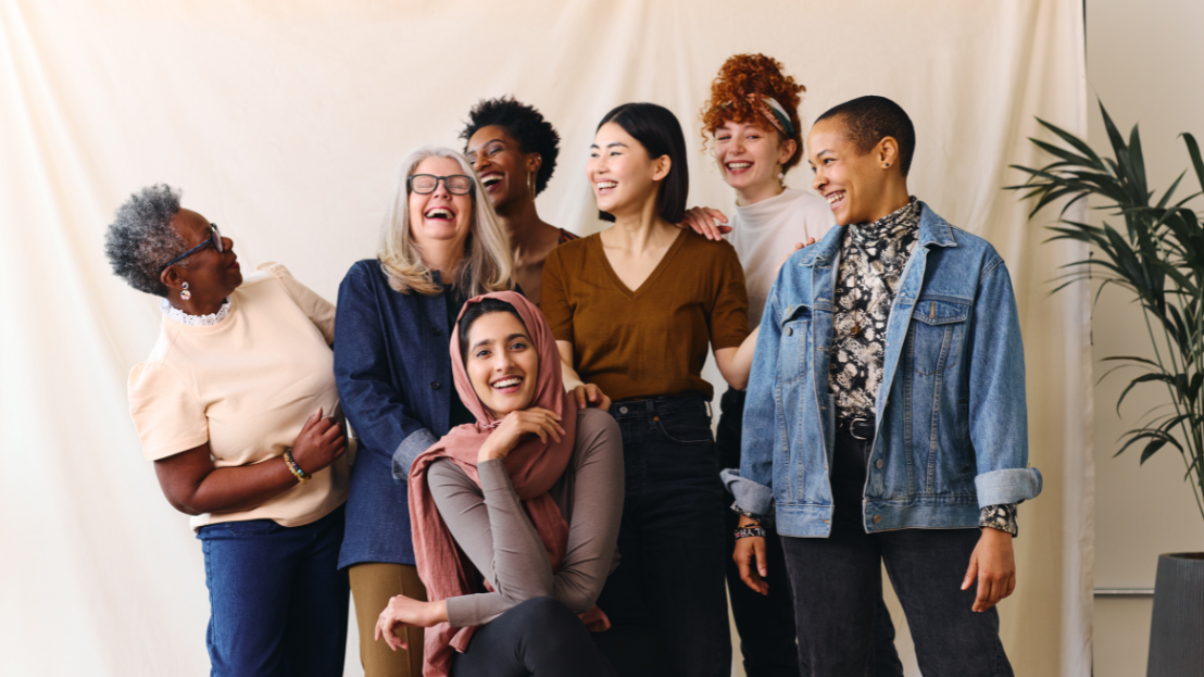 Group of diverse female colleagues laughing and smiling
