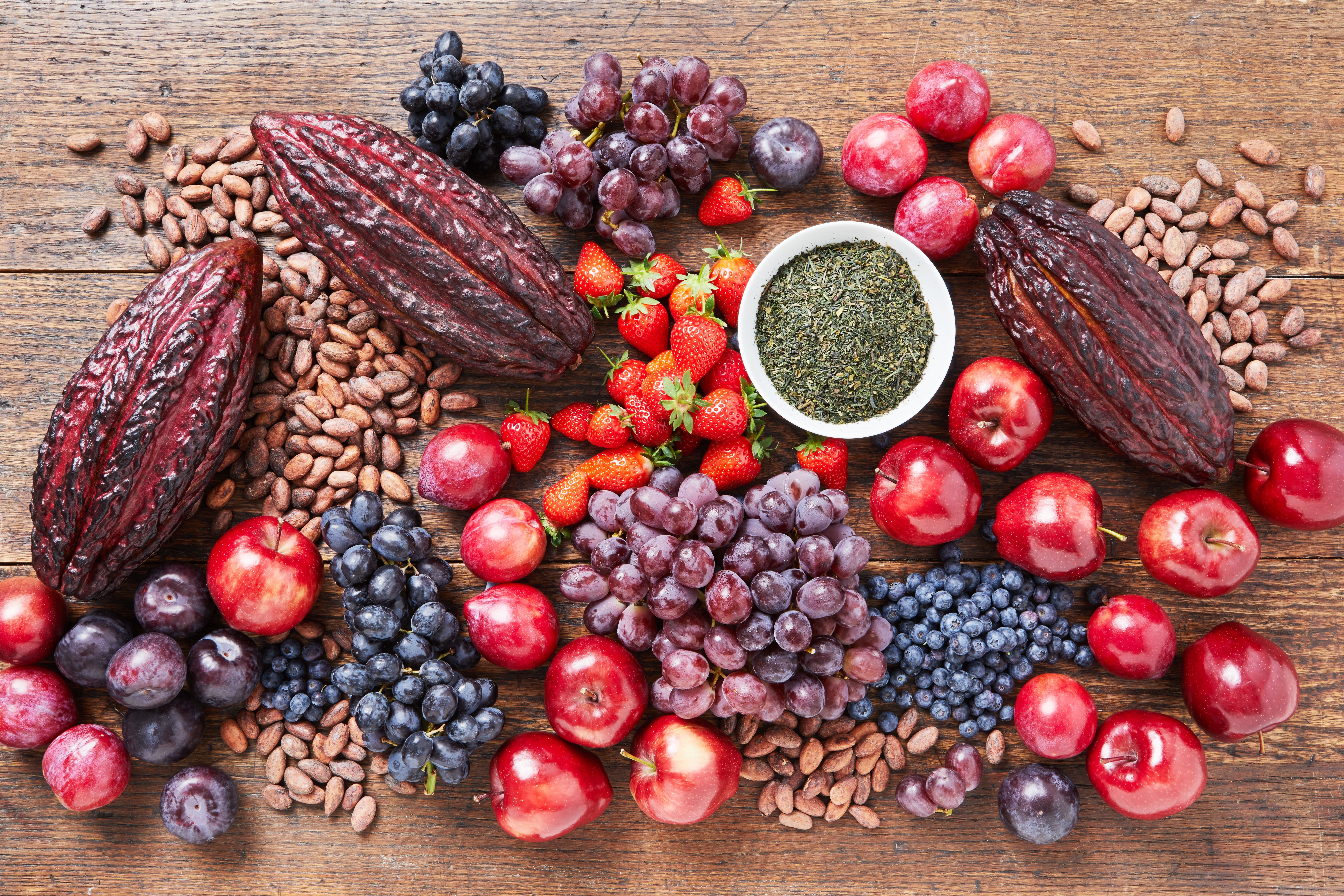 Cacao pods with various fruits on a table