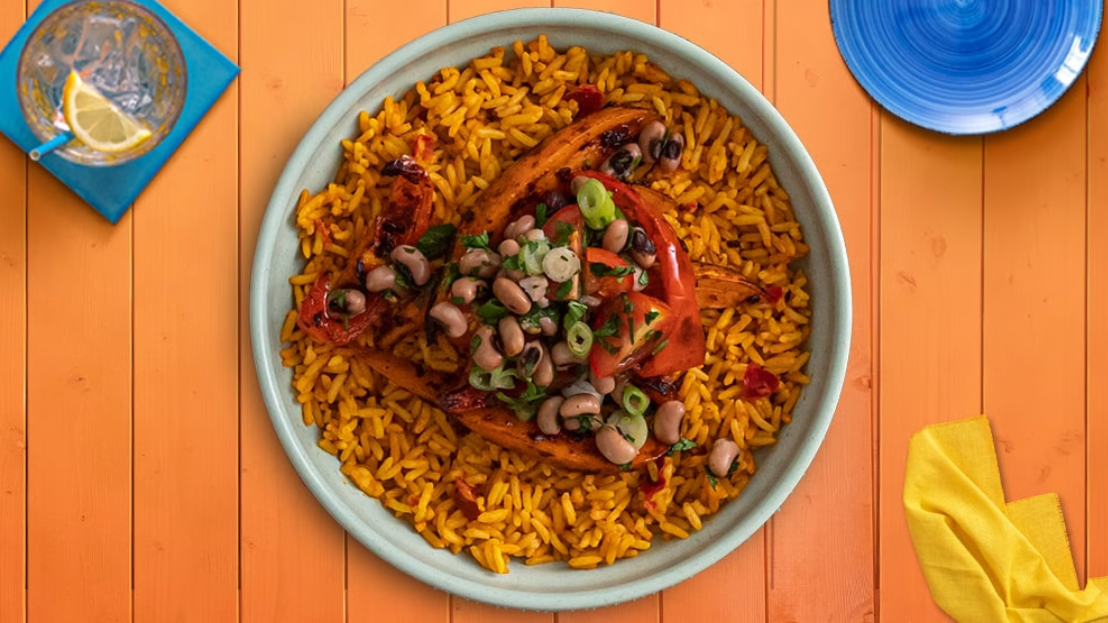 A bowl of rice with vegetables on a table