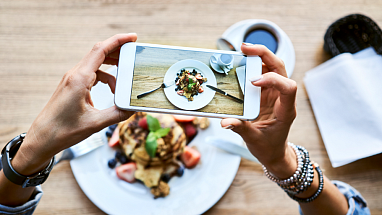 A women takes a picture of her delicious meal