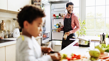 Father and son cooking in kitchen