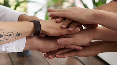 Group of peoples' hands stacked on top of one another