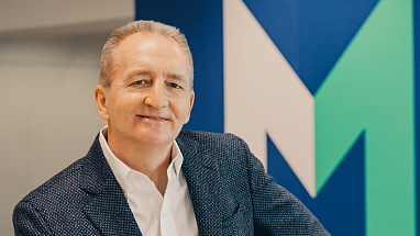 Grant F. Reid in front of the Mars "M"