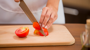 Chef cutting tomatoes