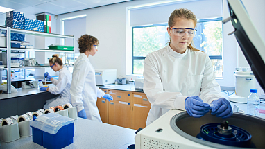 Three women working in a lab