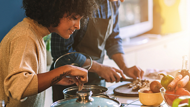 A couple cooking dinner in the kitchen