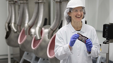 Female Mars Associate holding a packet of M&M's