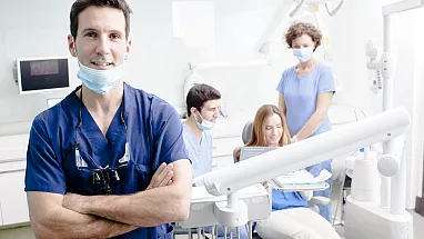 Dentist and staff near patient