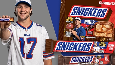 Josh Allen holding a SNICKERS bar