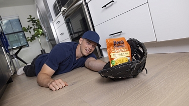 Baseball player Ben Rice catching a package of Ben's Original rice