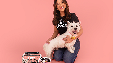 Lacey Chabert poses with the CESAR dog mascot and limited-edition Pink Packs.