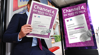 A man sitting at a bus stop, reading Whiska's open letter to Channel 4.