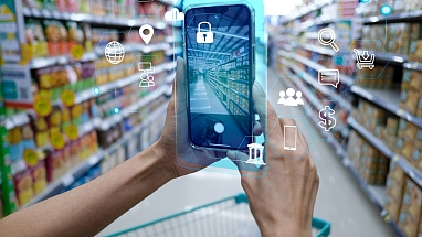 Person holding a smartphone in a grocery aisle