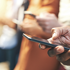 A hand holding a smart phone