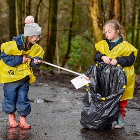 Young girls cleaning up trash