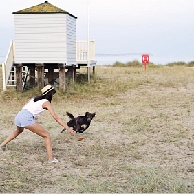Woman and her dog on the beach