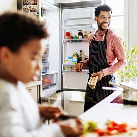 Father and son cooking in kitchen