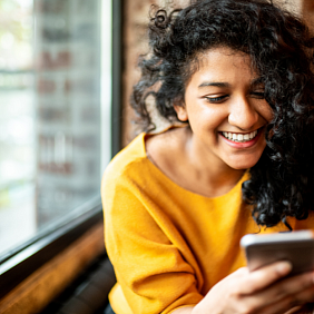 Smiling young woman using a mobile phone