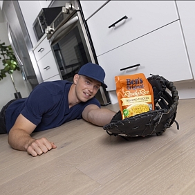 Baseball player Ben Rice catching a package of Ben's Original rice