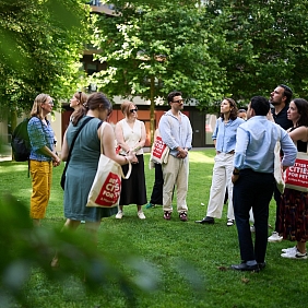 People gathering in the grass at Kings Cross, London.